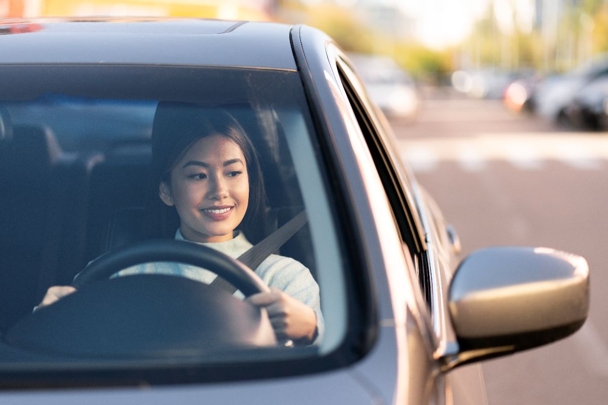 Woman driving through the city, showing the convenience and mobility of Metro Manila living