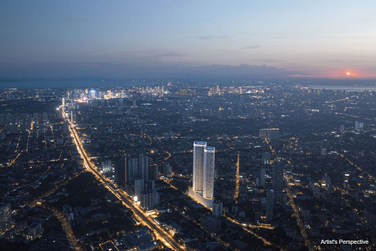 Aerial view of Quezon City at dusk showing illuminated roads, surrounding developments, and the Shang Summit towers
